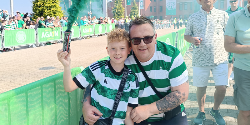 Lyle and his son at a football match